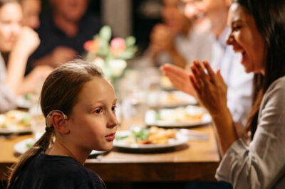 AT FAMILY DINNER, MY SISTER MADE FUN OF MY DAUGHTER’S HEARING AID —MY DAD SAID,“RELAX, IT’S A JOKE.”